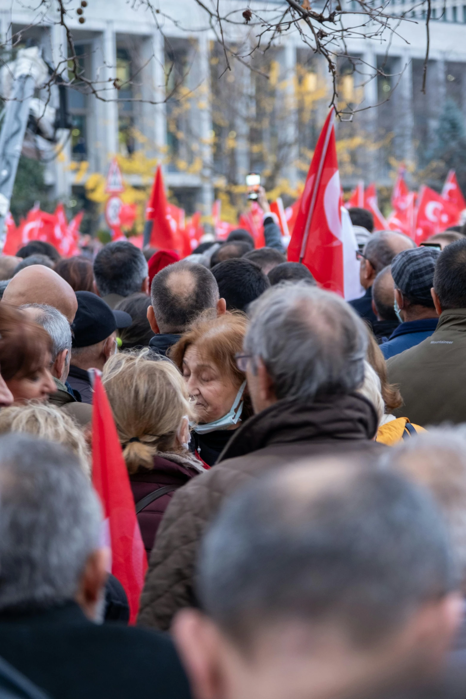 a large group of people marching down a street