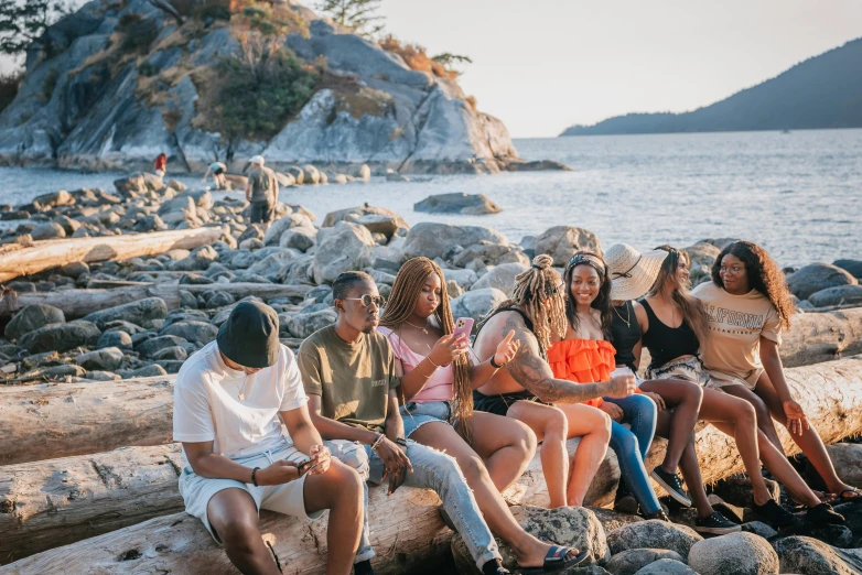 a group of people that are sitting on a rock