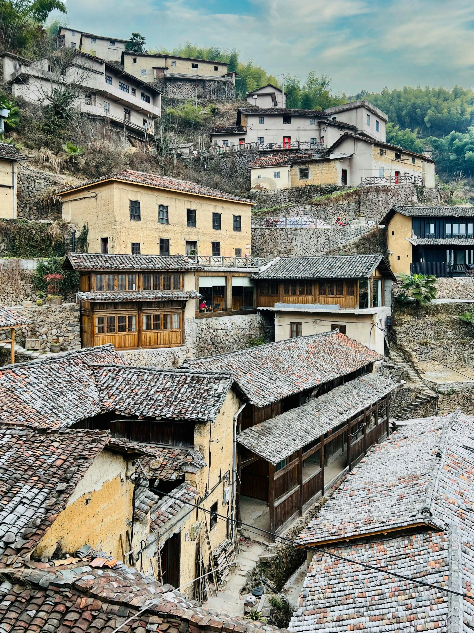 many old buildings are seen with a mountain behind them