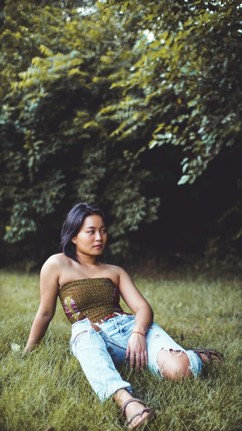 an image of a girl that is sitting in the grass