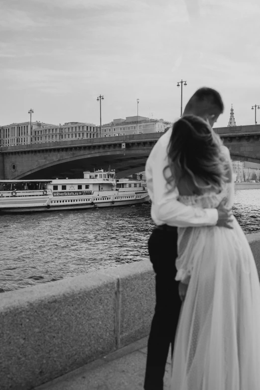 a newly married couple on the edge of a lake