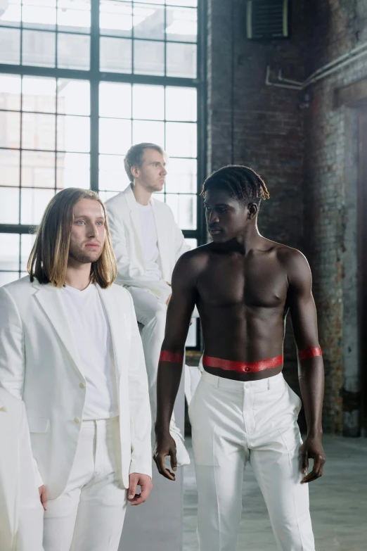 models posing for the pographer from front to back in white suits and suit whites