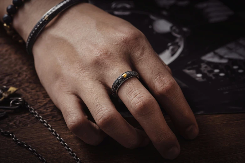 a person's hand with a diamond ring