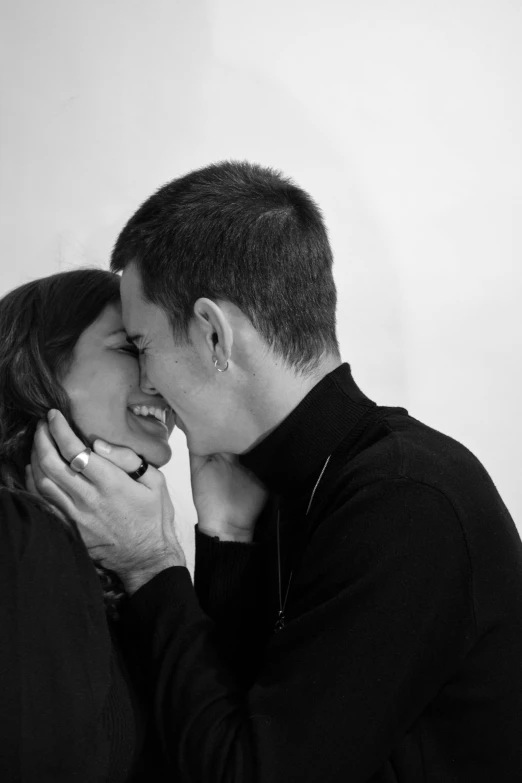 a couple is emcing each other in black and white