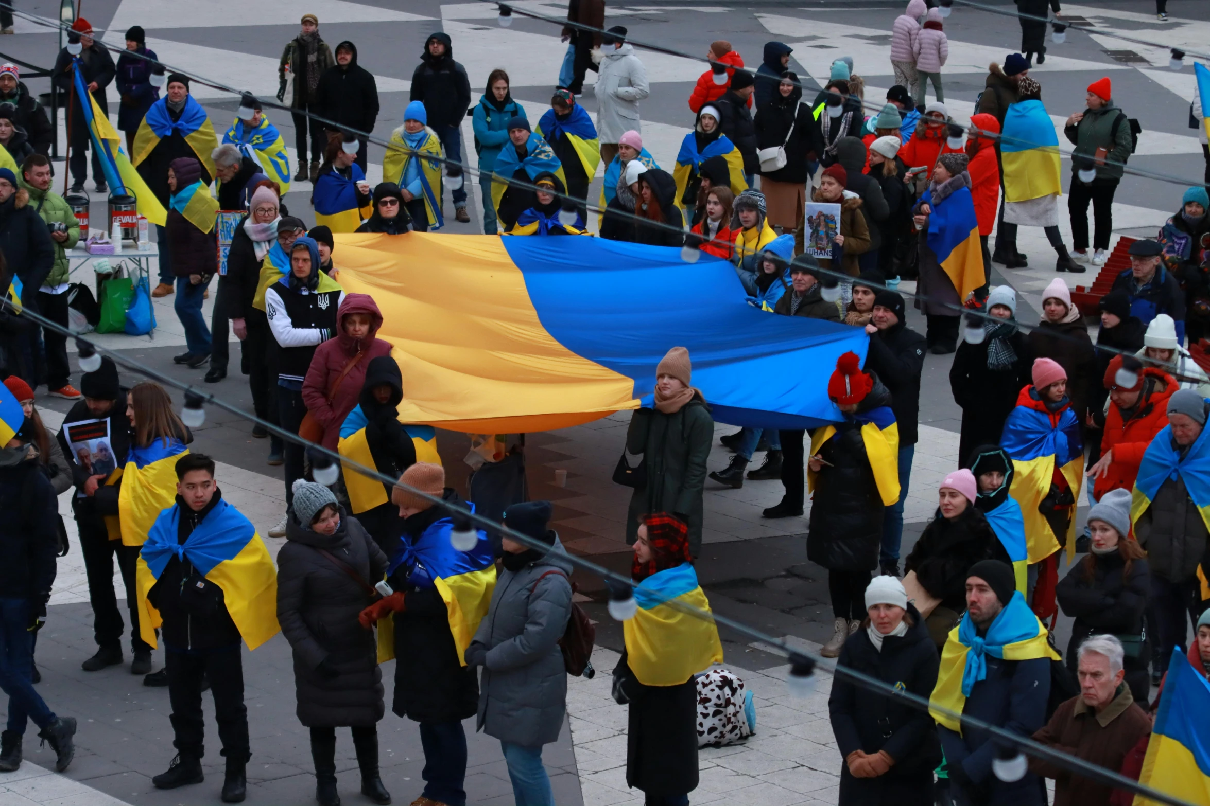 several people are walking and some have flags on them