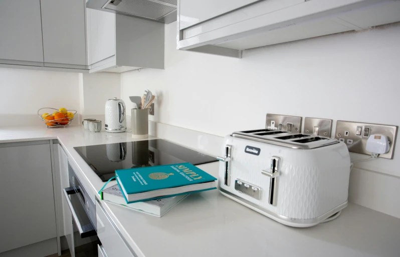 a toaster is on a kitchen counter with a book