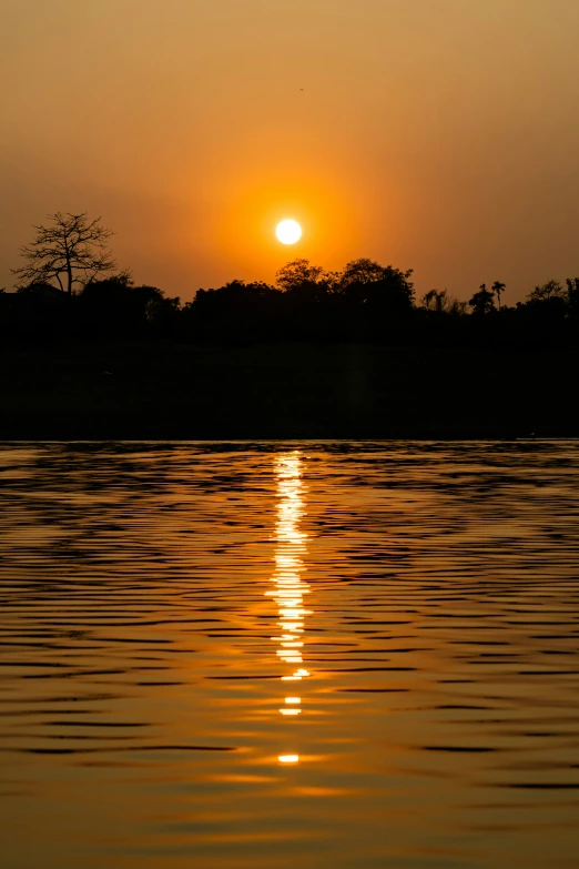 a boat is out on the water at sunrise