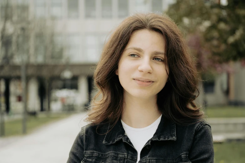 a young woman is posing for a picture on the street