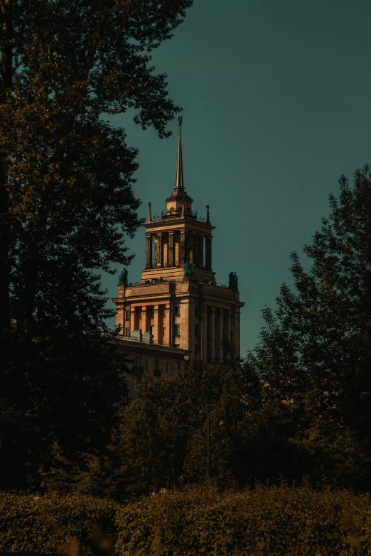 an old building sits in a park with trees