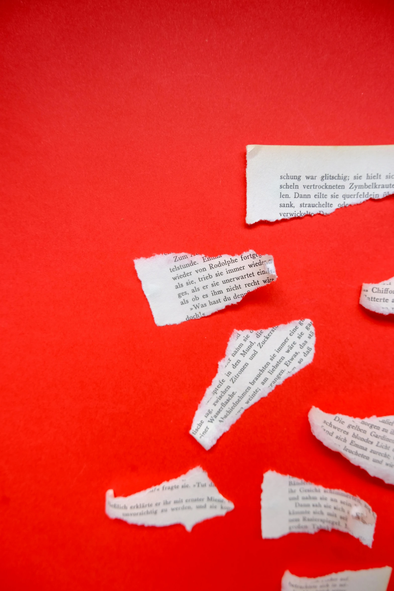 a close up of some pieces of newspaper on top of a table