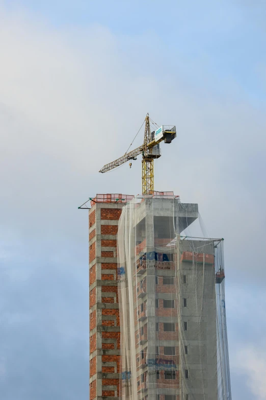 a crane on top of a skyscr in a city