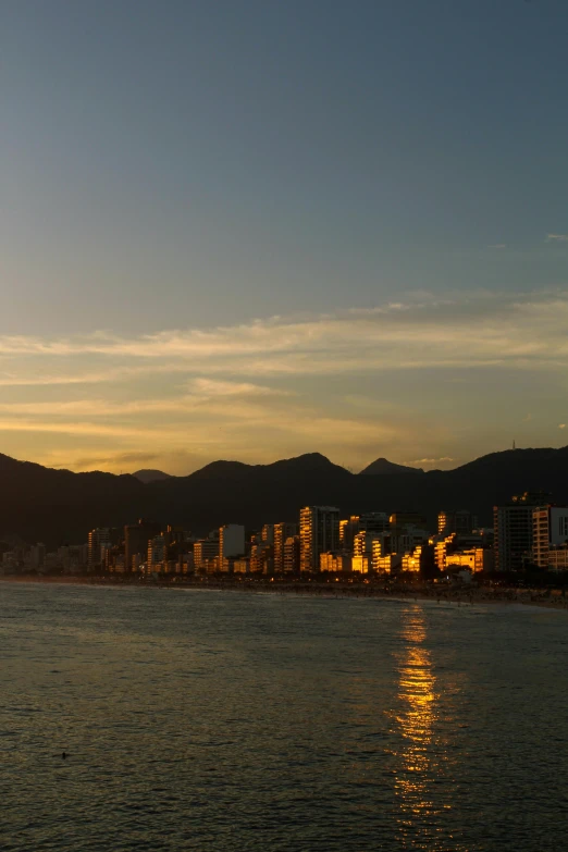 a large body of water with buildings in the background