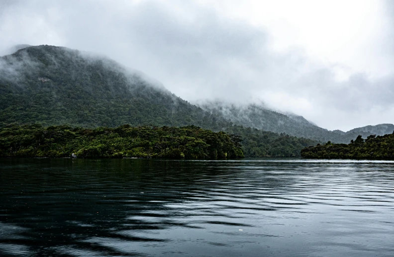 dark, rainy clouds cover an island and forest