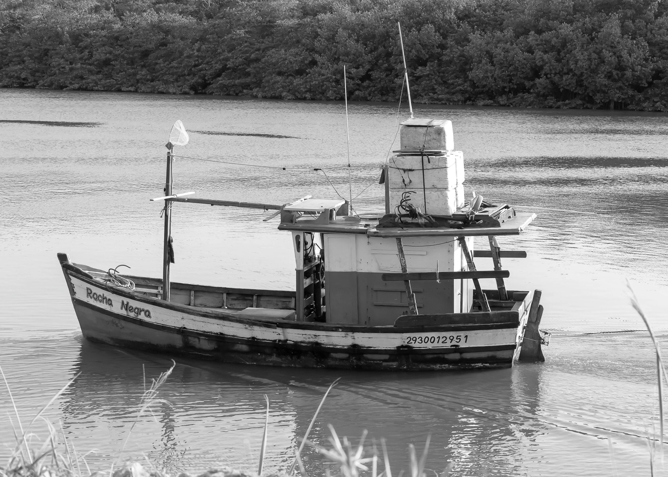 a black and white po of a boat on a lake