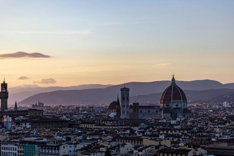 the view of a city with mountains in the distance