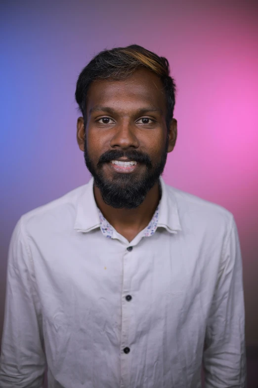 a close - up of a man wearing a on - up shirt and smiling