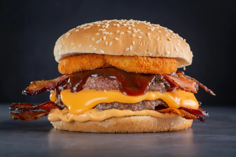 a bacon, cheese and tomato burger with ketchup