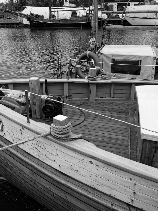 a boat docked at a pier near a harbor