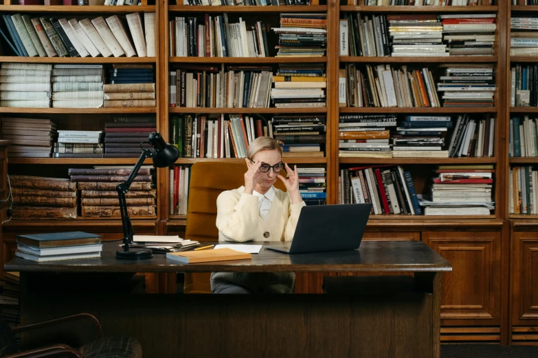 a man that is sitting in front of a laptop