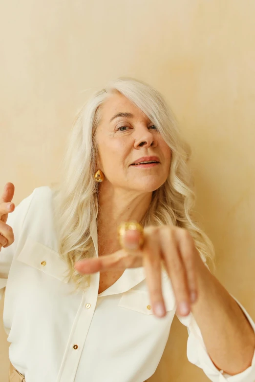 an older woman is standing in the room with her finger pointing at soing