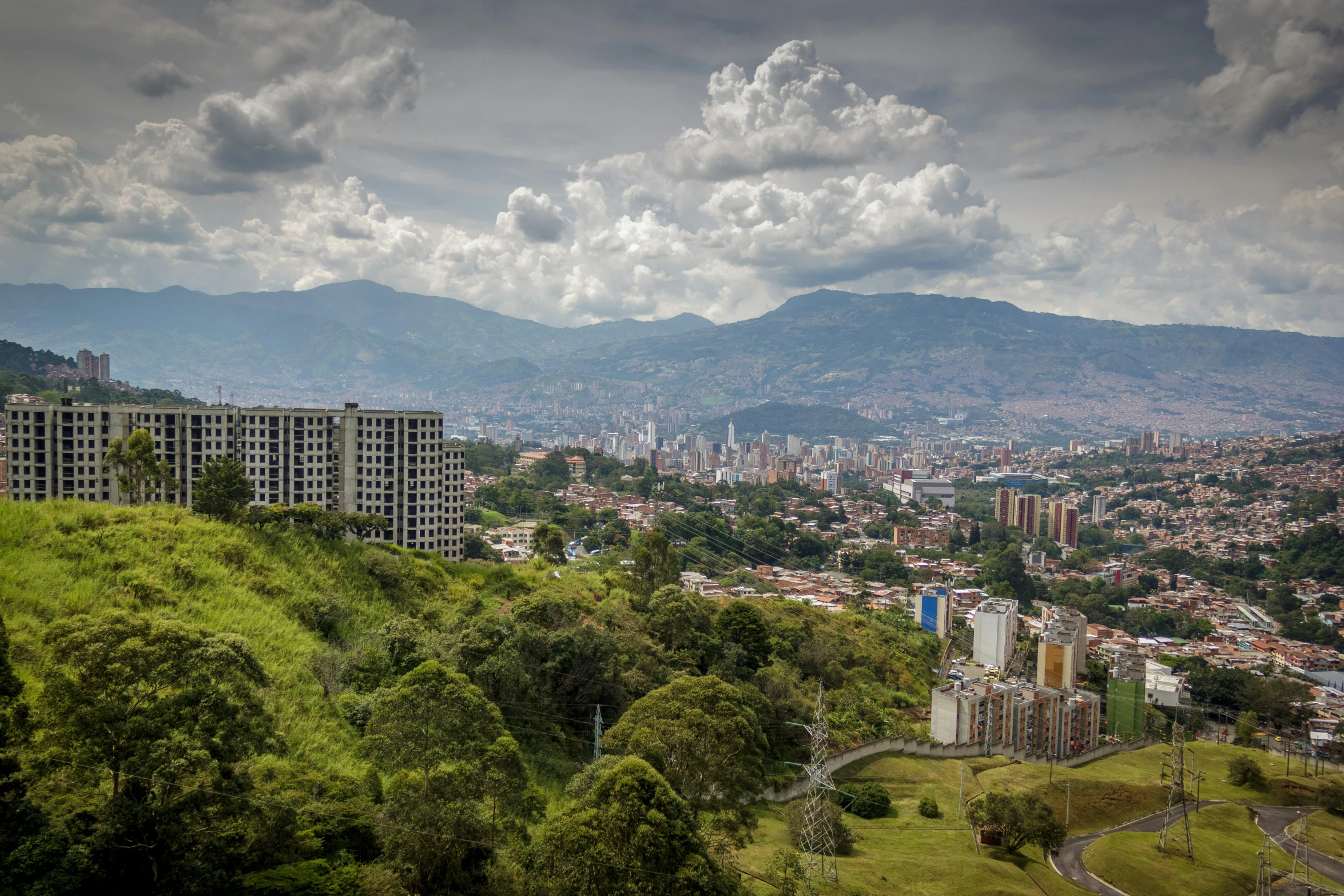 a large hill in a city surrounded by tall buildings