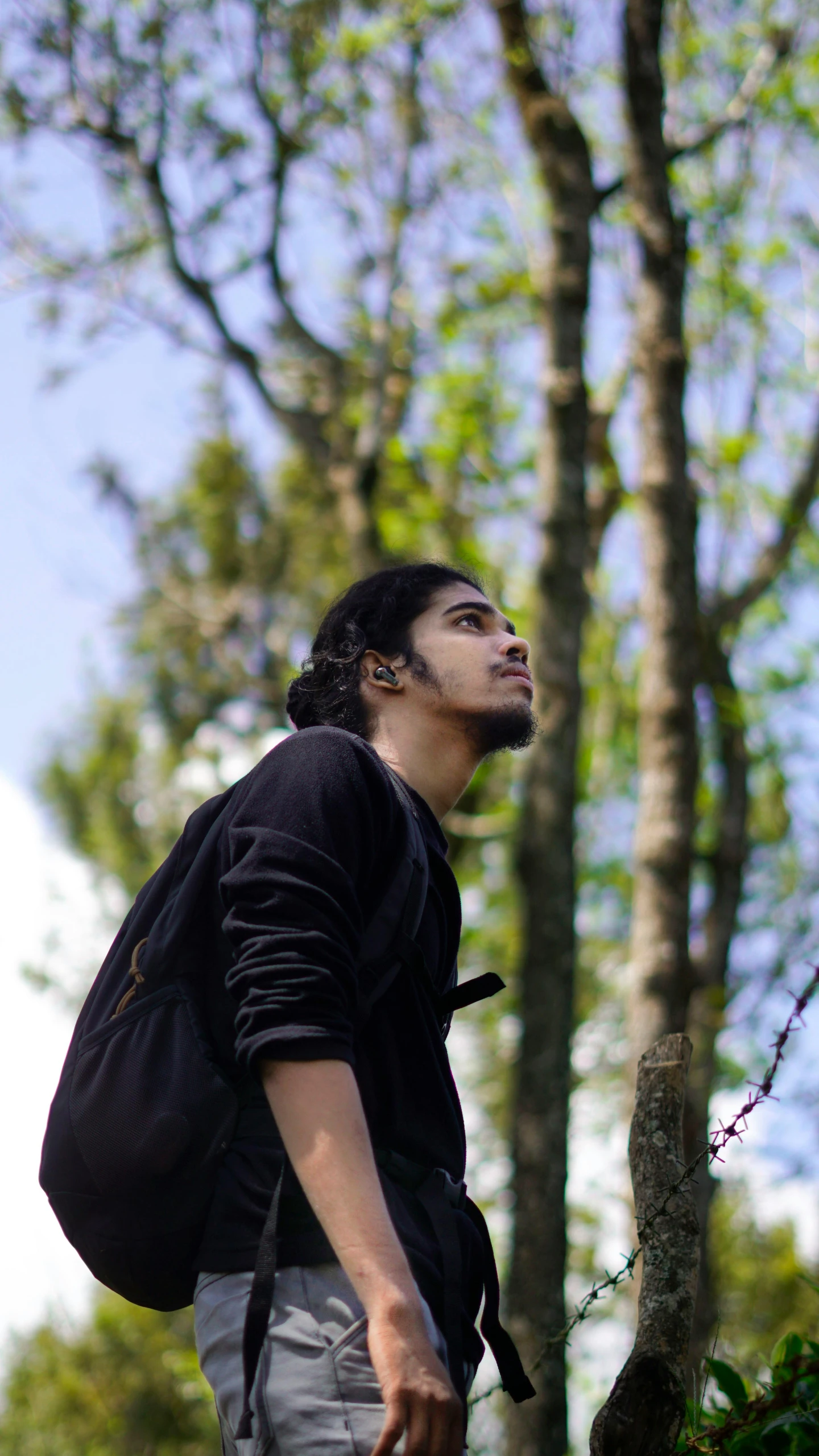 a man walking in the woods next to some trees