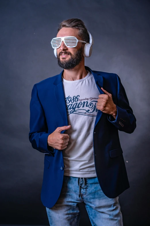 a man wearing glasses and shirt pointing to his left