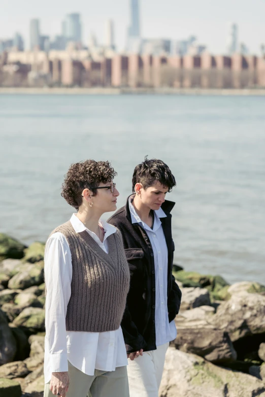 a woman and a boy looking at soing in the distance