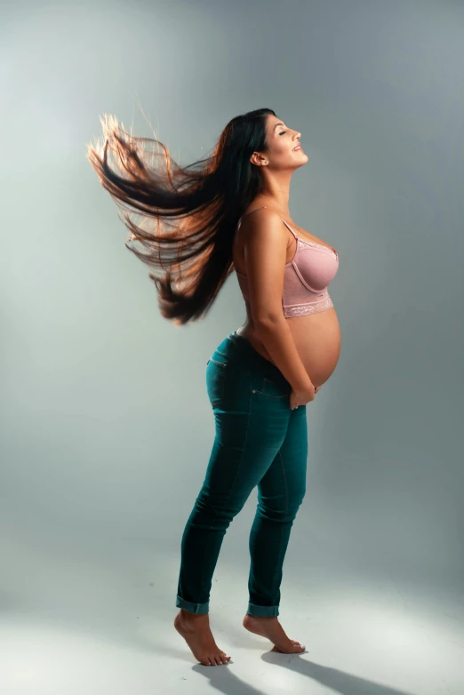 a pregnant woman standing with long hair