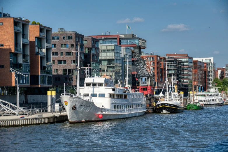 the yachts are docked on a city waterway