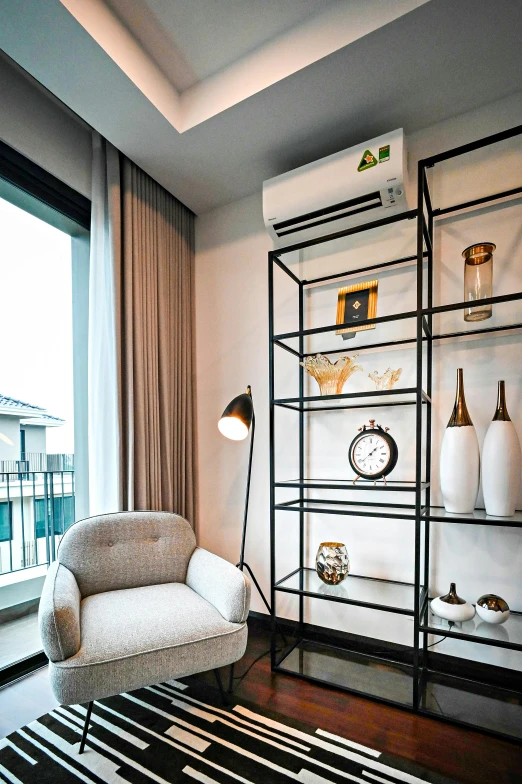 an empty room with a chair, window, and book shelf