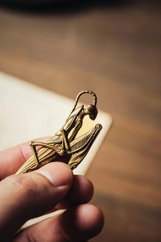 a gold piece sitting in a persons hand