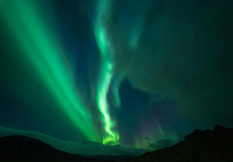 the northern lights over a mountain range