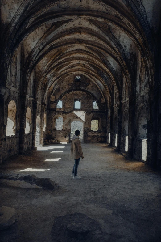 the man is walking in the empty building