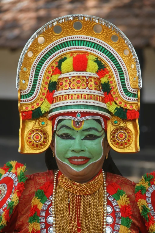 a person with a bright green face paint and green hair