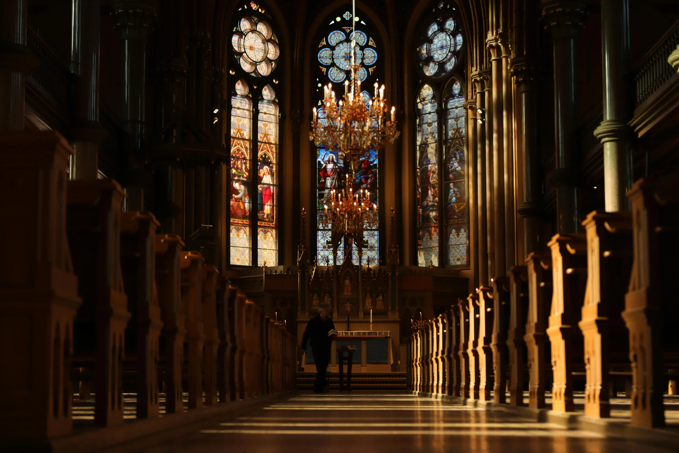 an empty cathedral with large stained glass windows