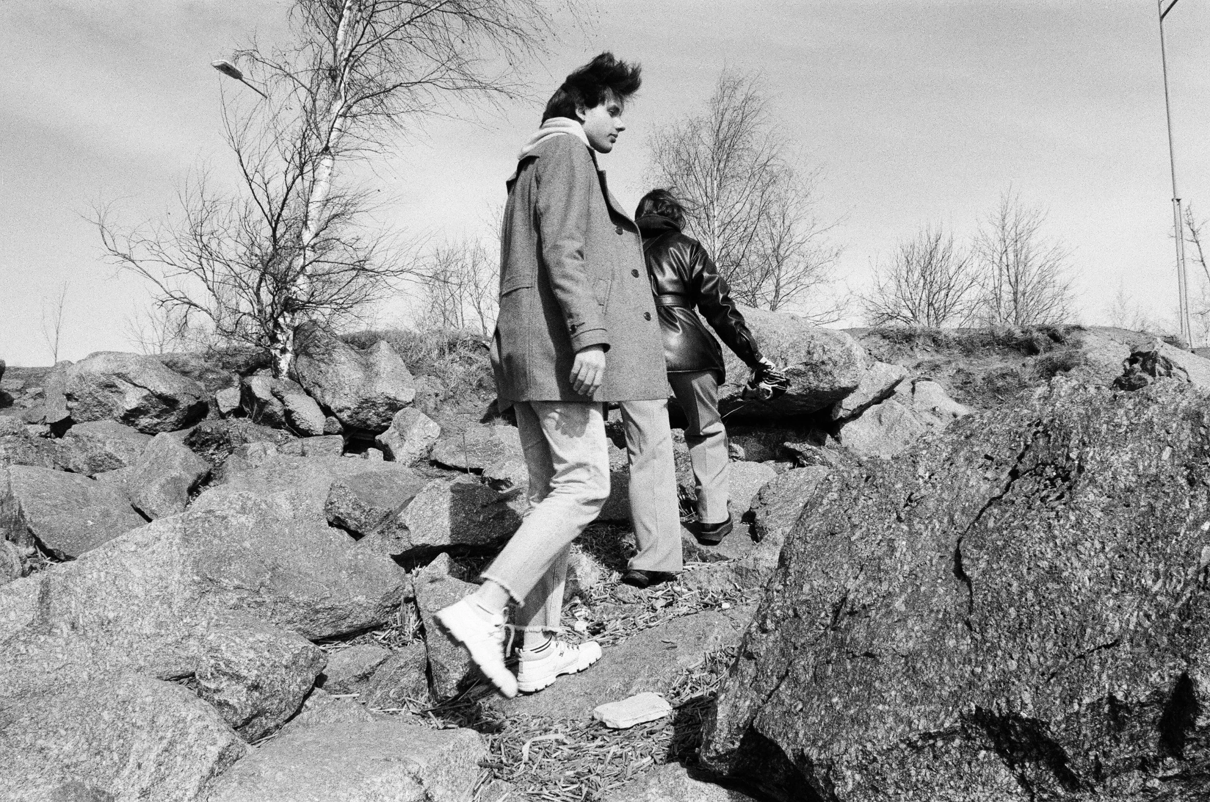 a man and a child walking across a rocky surface