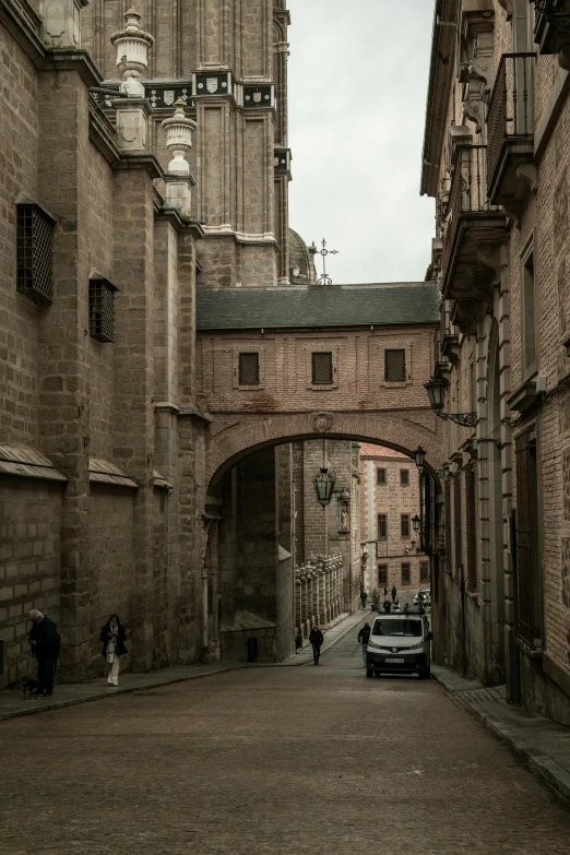 a car is driving down a street in an old town