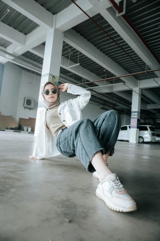 a woman with head scarf laying on her side in an indoor space