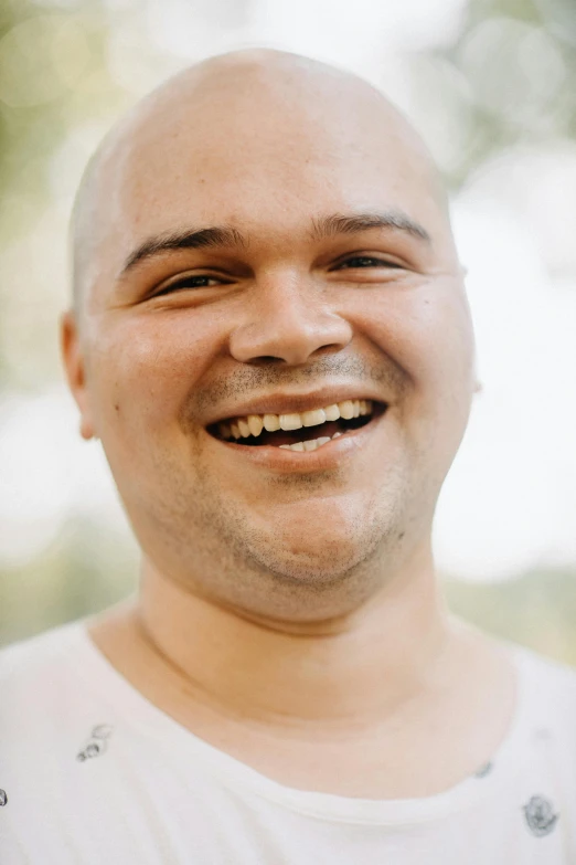 a balding man smiling for the camera