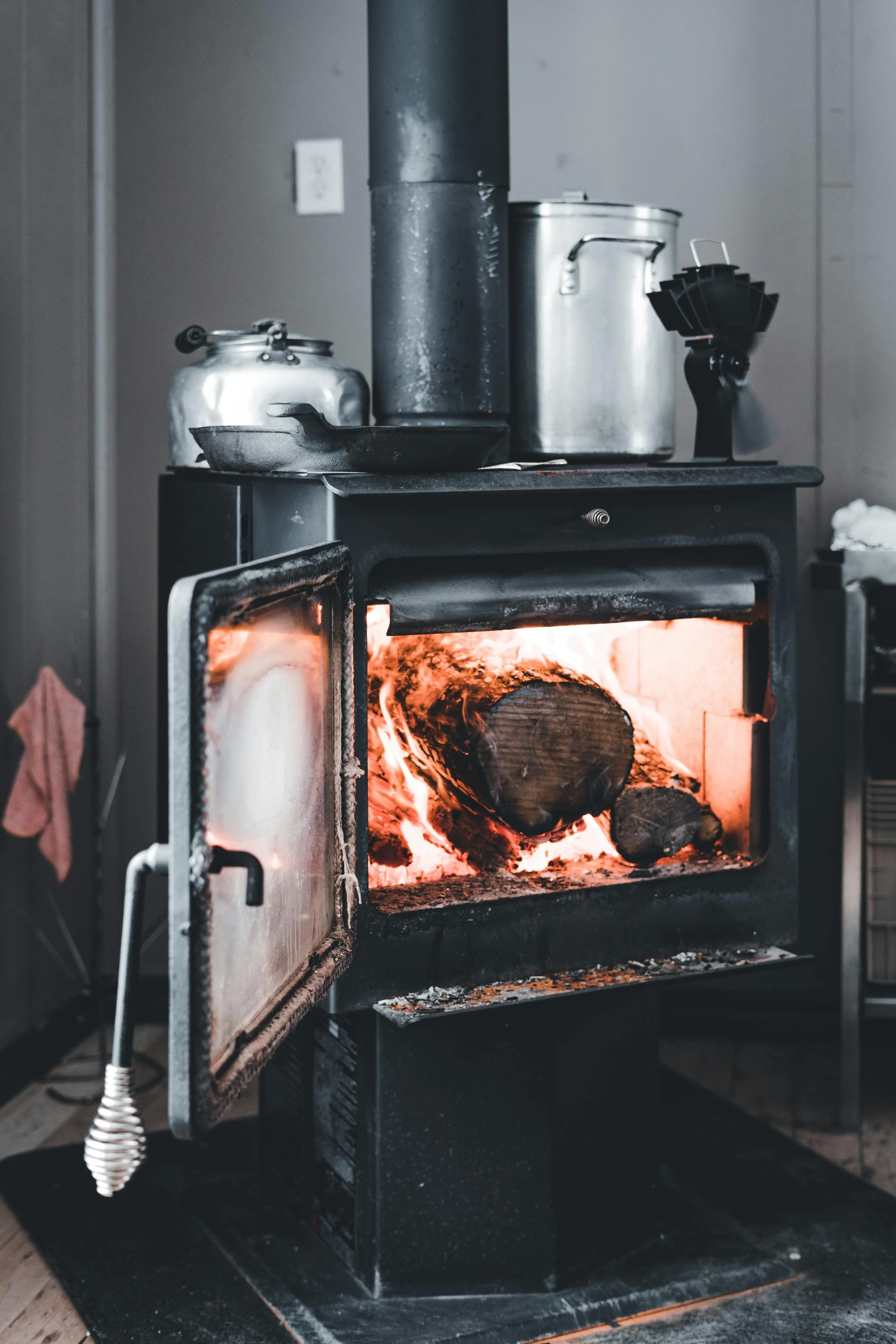 an open oven with cooking pots and kettles