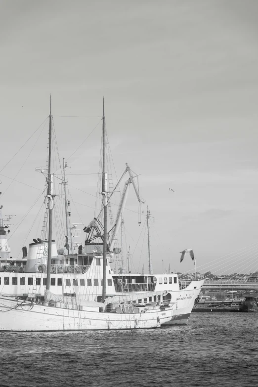 a large ship sailing past a dock on the ocean