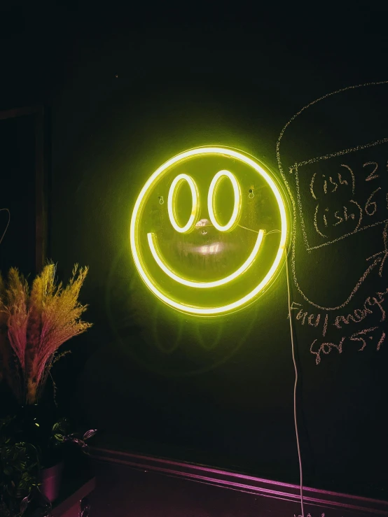 a neon sign in front of the door of a building