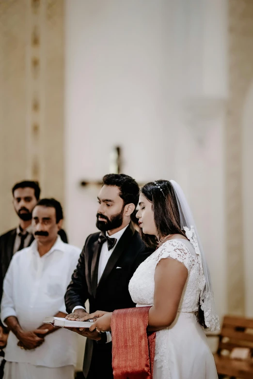 the bride and groom stand near each other during the alter