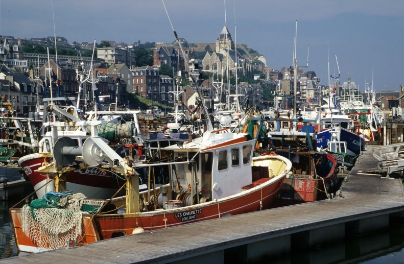 the many small boats are parked in the water