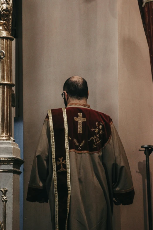 a priest is shown in his uniform with the cross