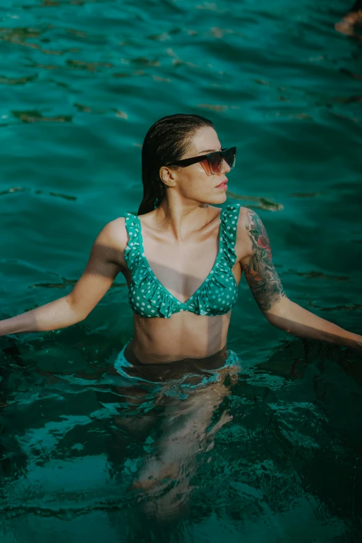 a girl with tattoo in the water