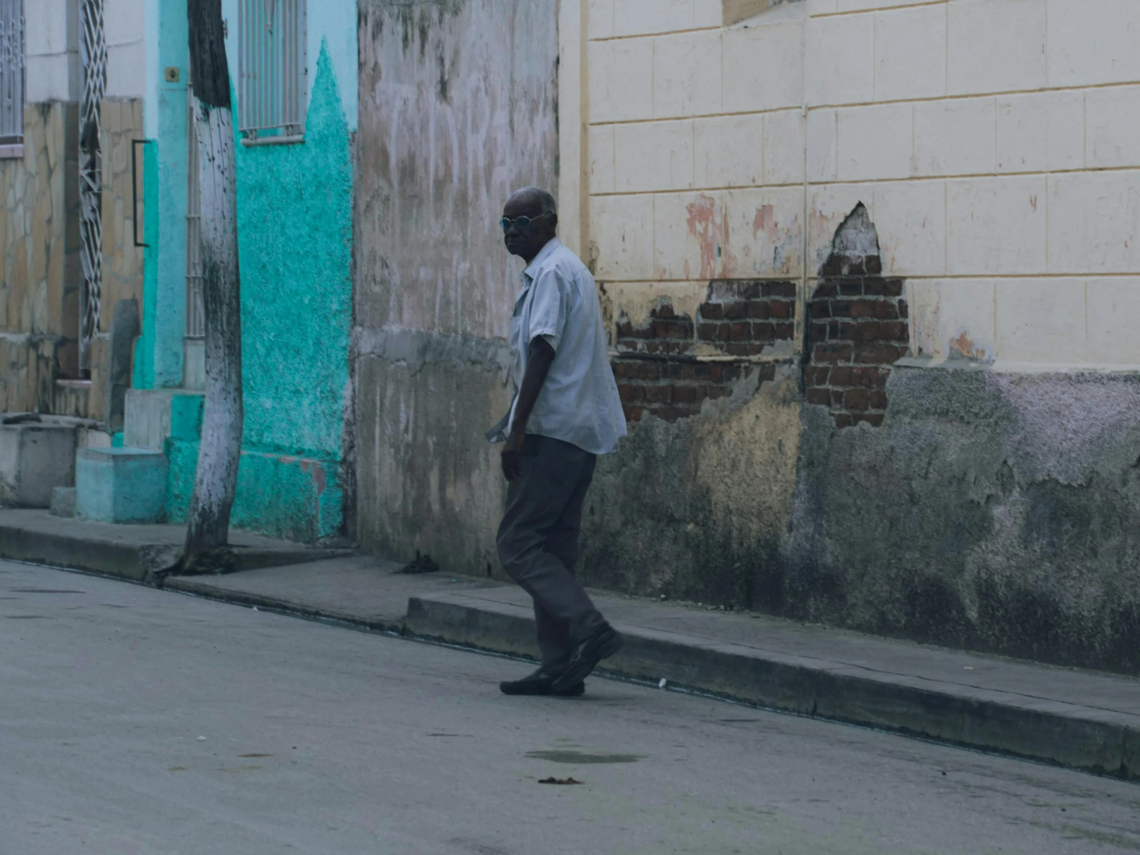 an old black man walking in the street