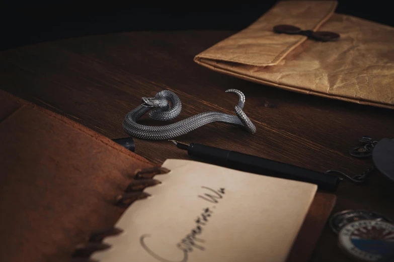 an old book and an envelope with a pen and quill