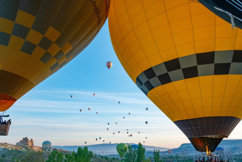 group of  air balloons floating in a blue sky